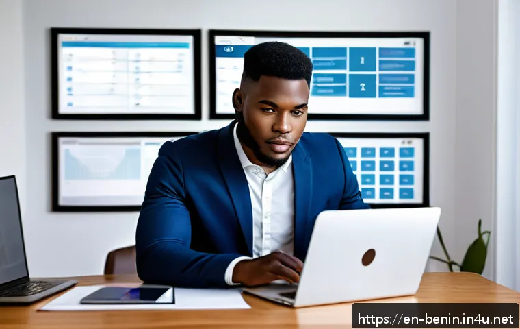 베냉에서 해외 취업 기회 - A professional young African man in a modern home office setting, working on a laptop with multiple ...